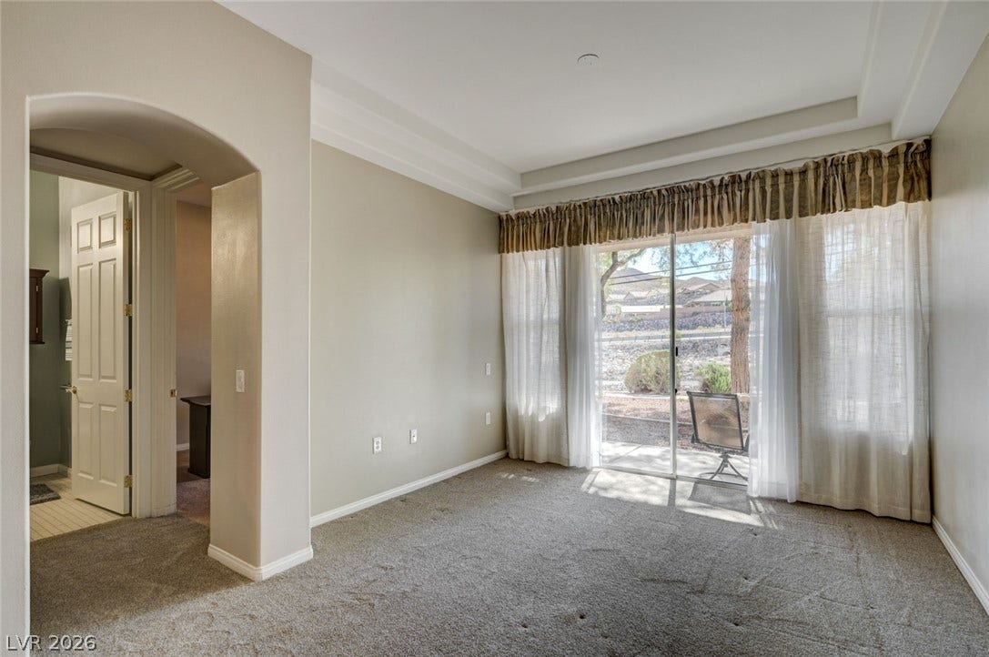 207 Kaelyn Street, #5, Boulder City, NV 89005 Sliding glass doors open to the outdoors from this carpeted room featuring a tray ceiling.