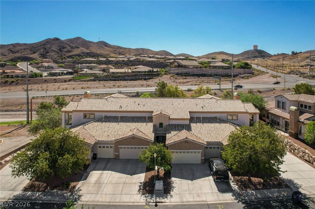 207 Kaelyn Street, #5, Boulder City, NV 89005 Rugged mountain ridges frame this multi-unit residential property set under clear blue desert skies.