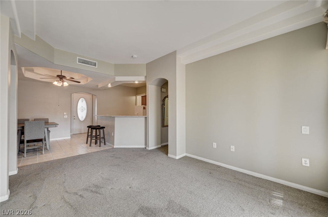 207 Kaelyn Street, #5, Boulder City, NV 89005 Plush carpeting and custom architectural archways define this versatile open-concept living area.