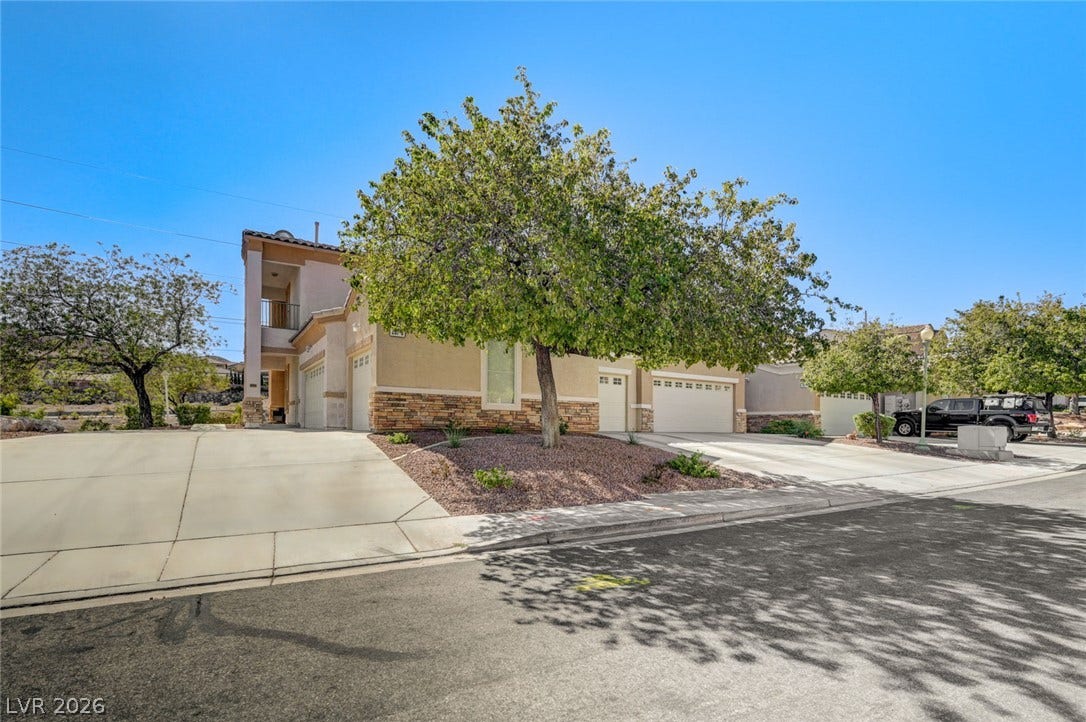 207 Kaelyn Street, #5, Boulder City, NV 89005 Suburban curb appeal highlighted by stone veneer accents and a wide concrete driveway.