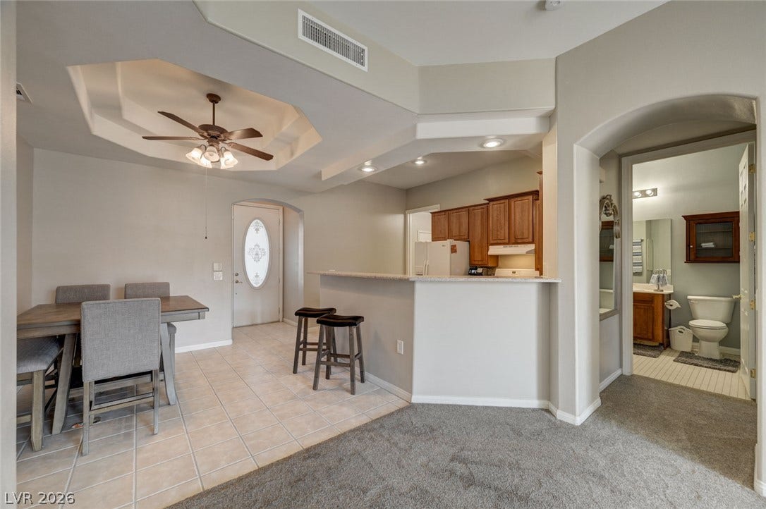 207 Kaelyn Street, #5, Boulder City, NV 89005 An open floorplan seamlessly connects the dining area, kitchen breakfast bar, and main living space.