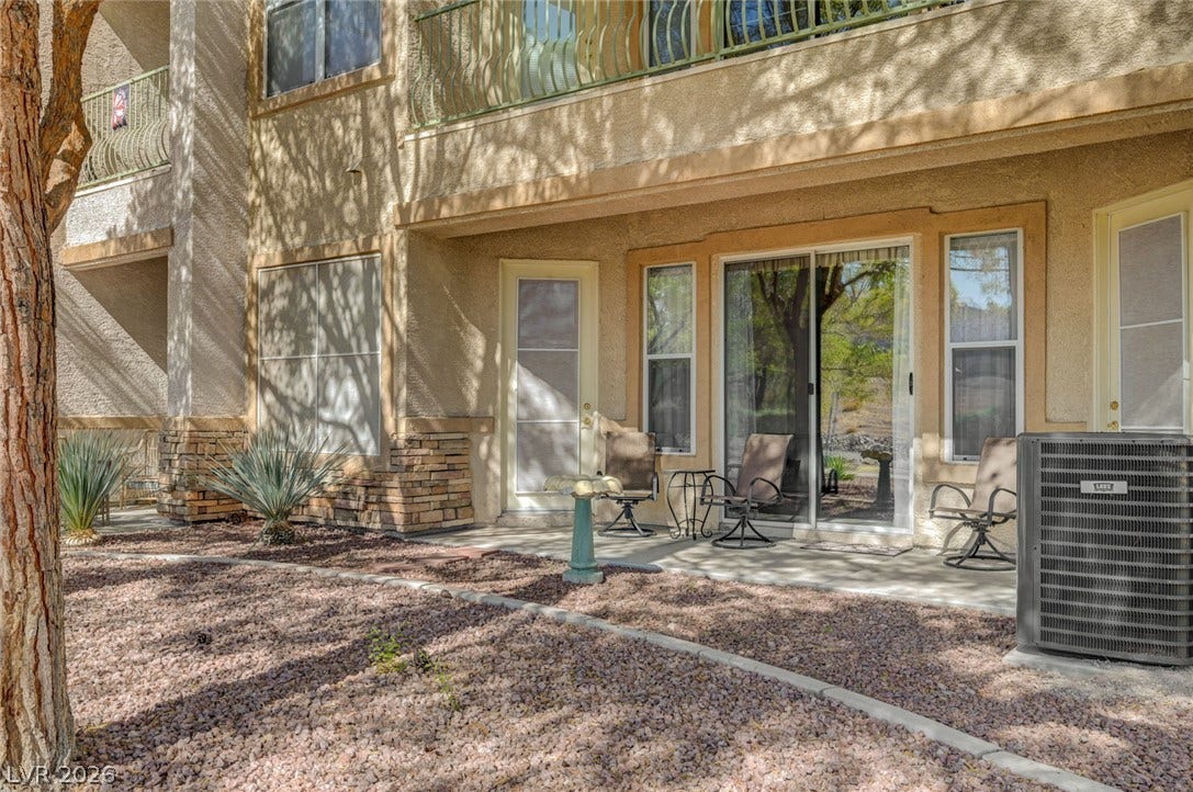 207 Kaelyn Street, #5, Boulder City, NV 89005 A private covered patio opens to xeriscaped grounds with mature trees and stone accents.