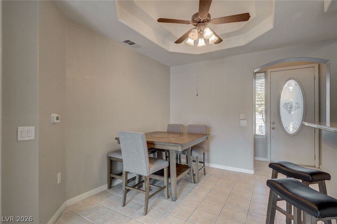 207 Kaelyn Street, #5, Boulder City, NV 89005 Tiled flooring and a tray ceiling define this welcoming entry and dining area.