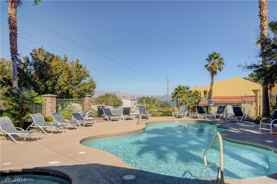 207 Kaelyn Street, #5, Boulder City, NV 89005 A sparkling community pool is surrounded by a spacious concrete deck and distant mountain views.