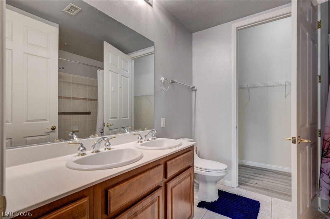 207 Kaelyn Street, #5, Boulder City, NV 89005 A classic double vanity offers ample counter space adjacent to a convenient walk-in closet.