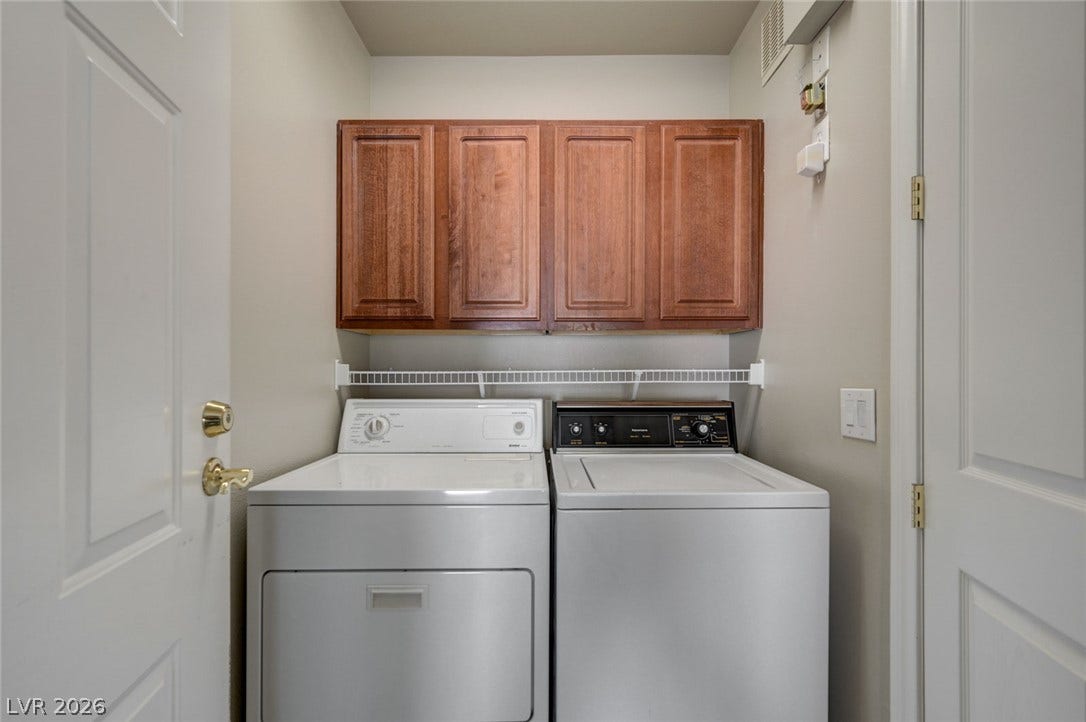 207 Kaelyn Street, #5, Boulder City, NV 89005 Functional laundry closet equipped with overhead cabinetry and storage shelving.
