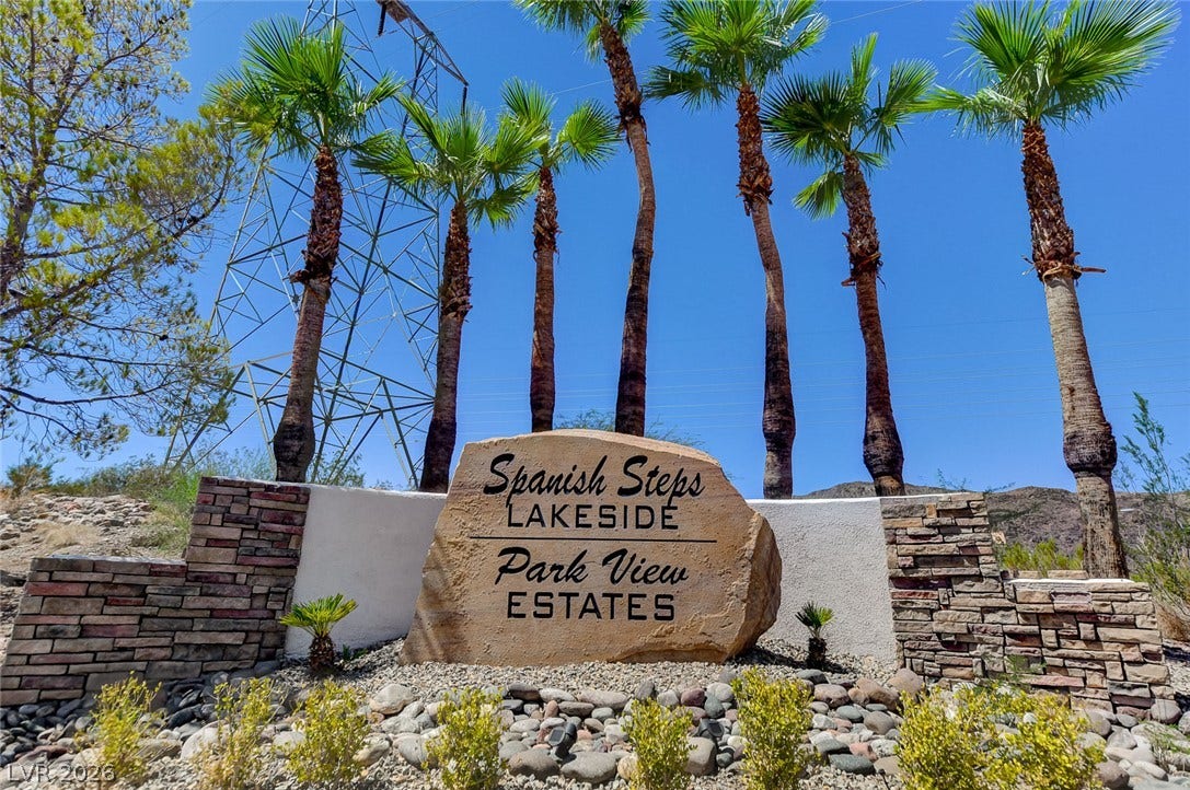 207 Kaelyn Street, #5, Boulder City, NV 89005 Towering palm trees frame the stone monument entrance welcoming residents to this community.