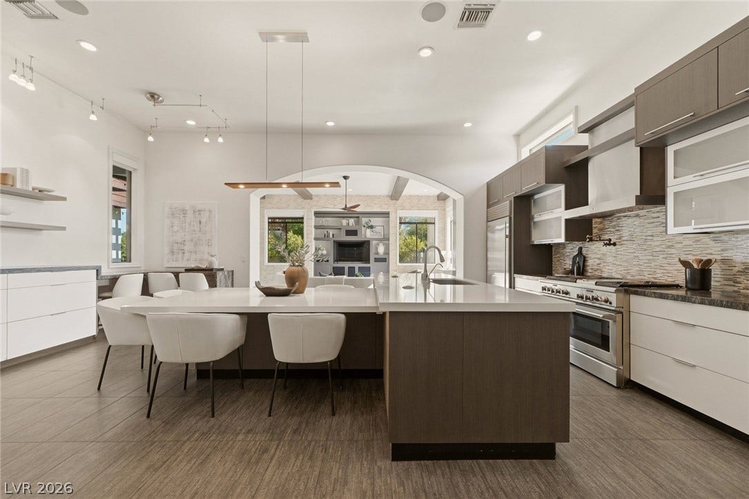 Clean lines and a spacious breakfast bar define this modern kitchen layout.