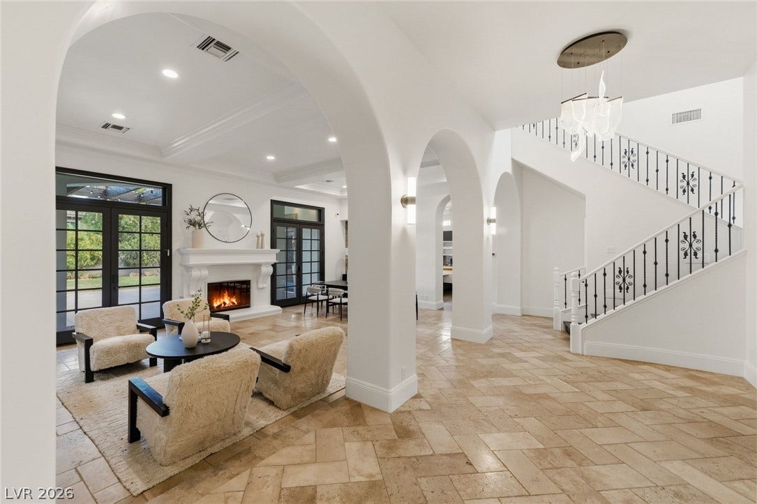 Graceful archways and stone flooring define this welcoming entryway.