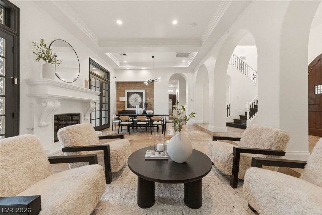 An elegant fireplace with a classic mantel anchors this open-concept main living area.