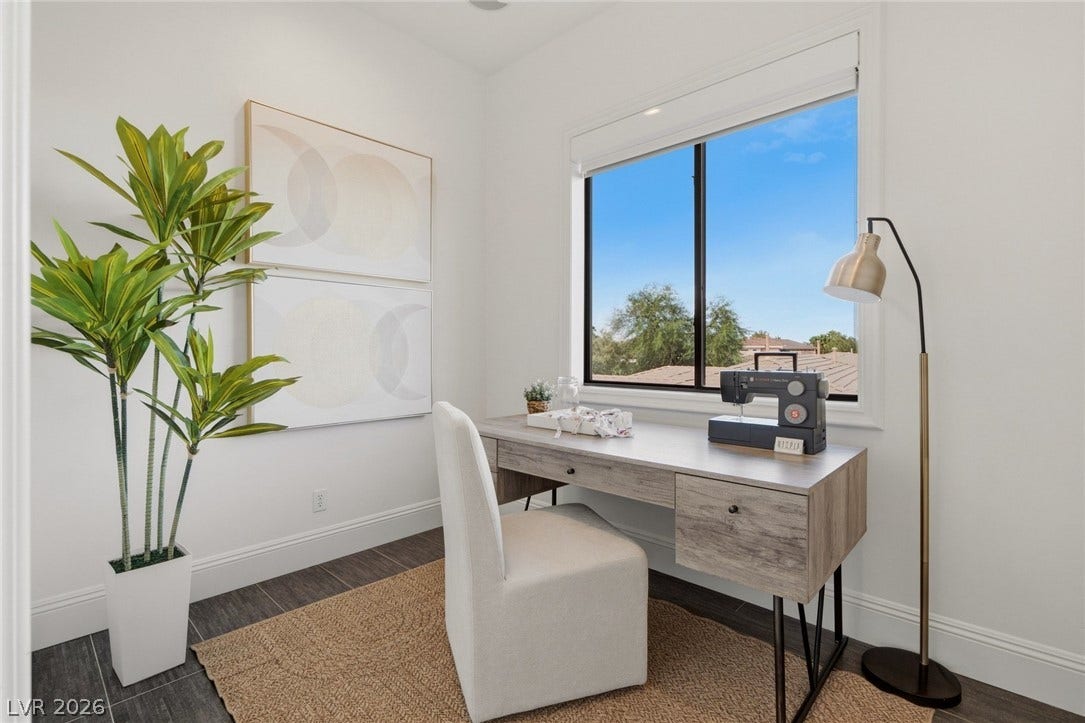 Natural light pours through a large window, highlighting the sleek tile flooring and baseboards.