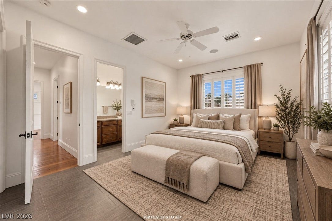 An inviting bedroom features clean-lined finishes and connects seamlessly to an en suite bath.