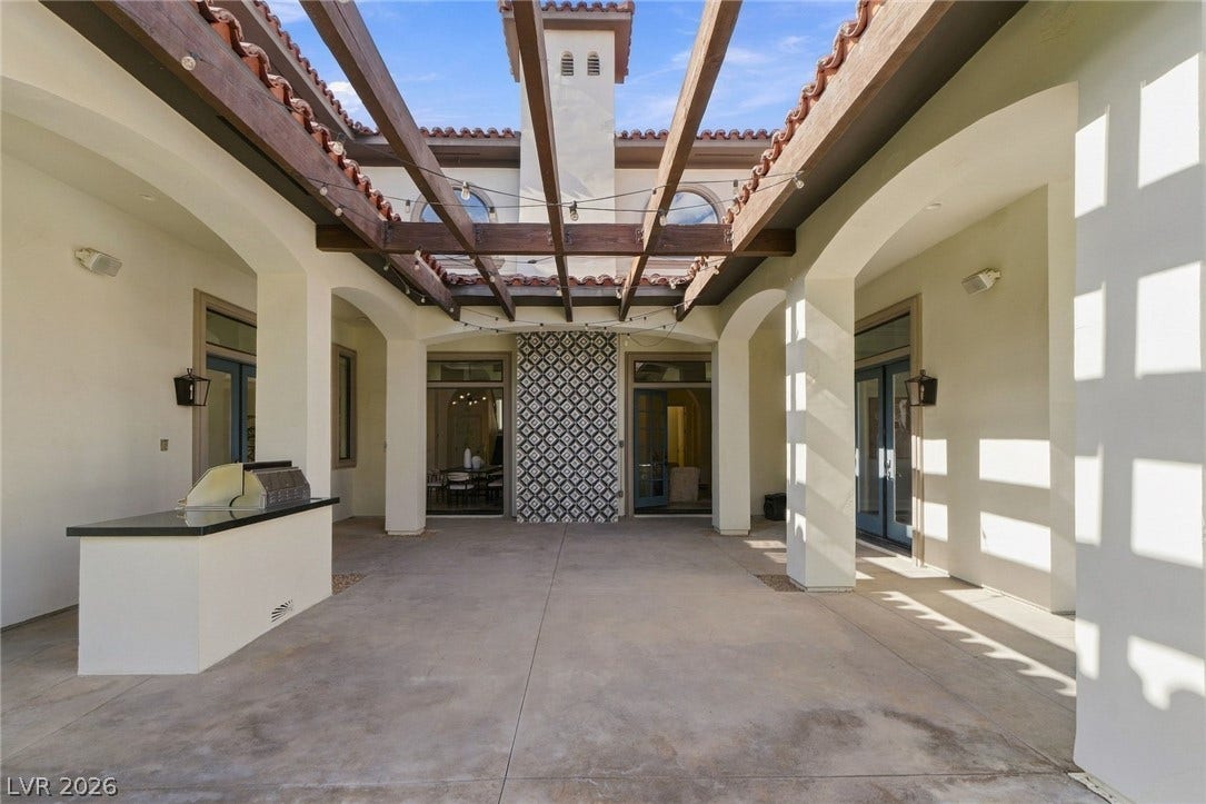 A spacious central courtyard features smooth concrete flooring under an open timber pergola.