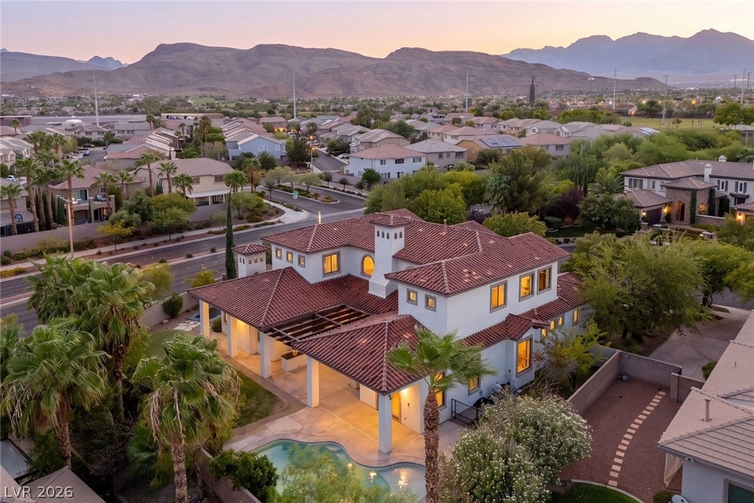 Dramatic mountain backdrops frame this elegant Spanish-style estate with a private pool.