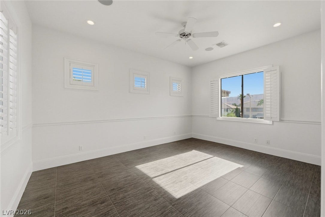 Gleaming tile floors and custom wainscoting define this versatile living space.