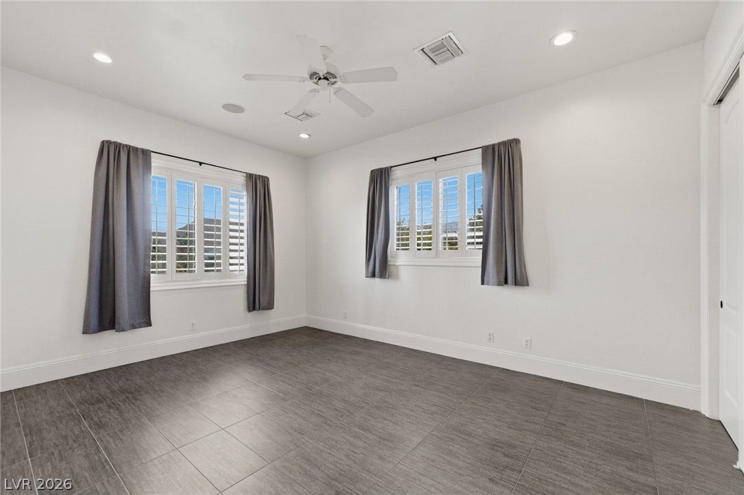 Crisp walls and modern tile flooring create a clean slate in this versatile room.