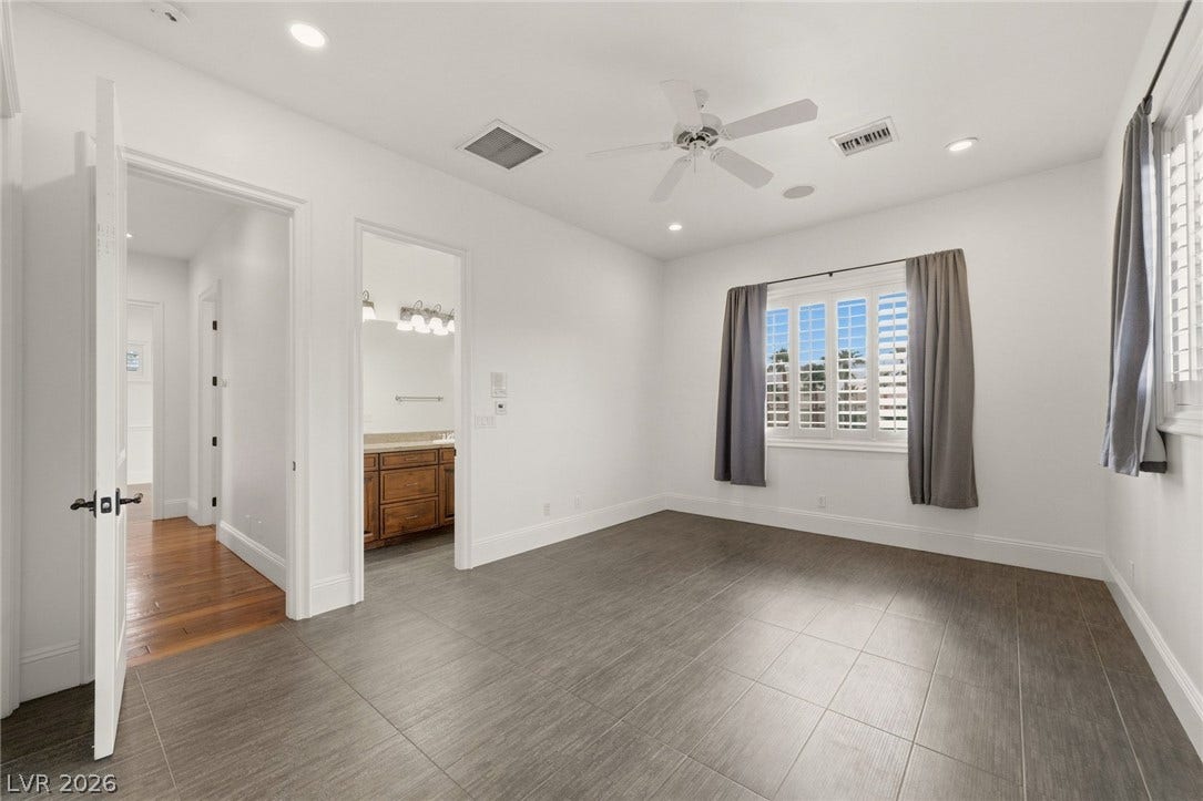 Sleek tile flooring and recessed lighting define this versatile, clean-lined bedroom space.