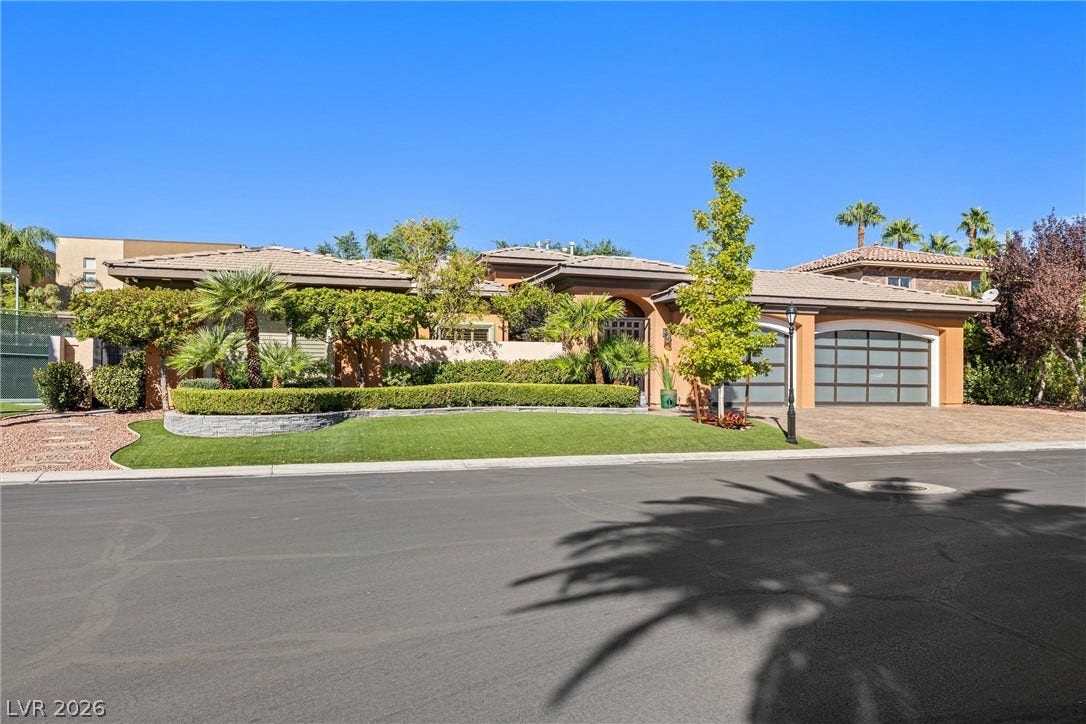 1517 Marbella Ridge Court, Las Vegas, NV 89117 Manicured landscaping and a sleek paved driveway enhance this elegant single-story home's curb appeal.