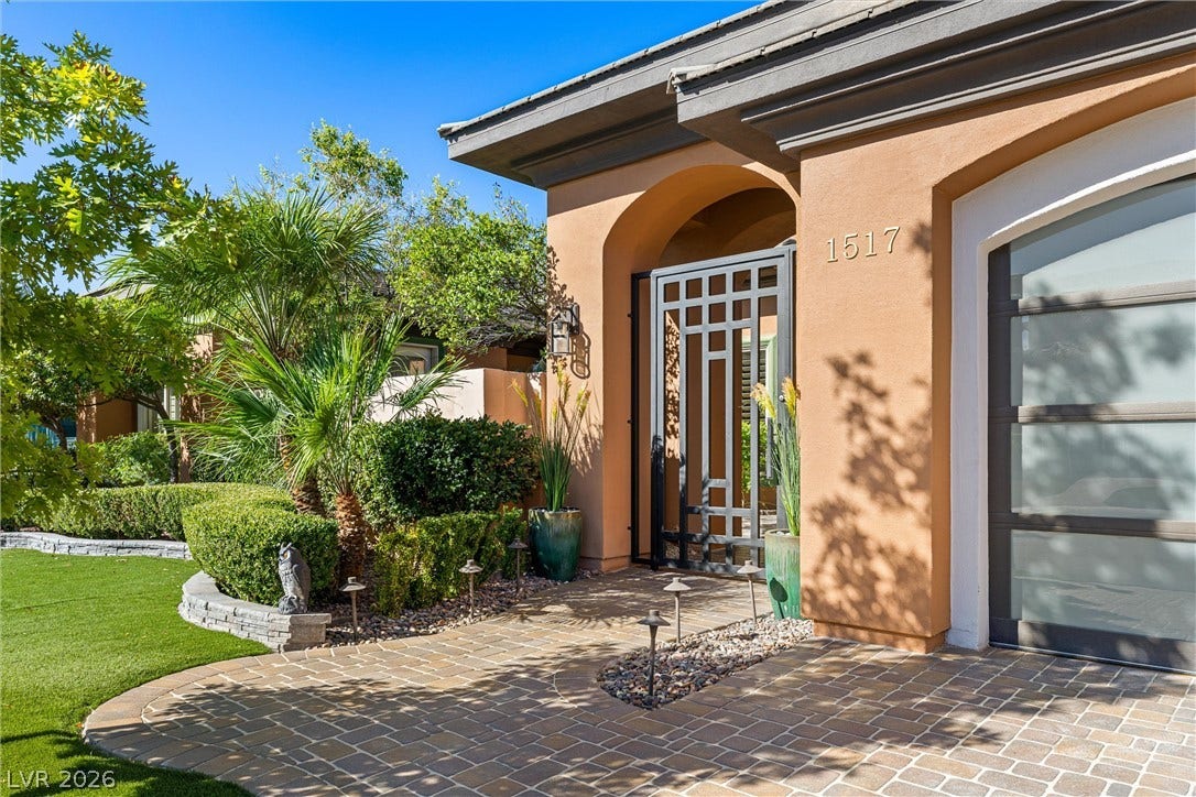 1517 Marbella Ridge Court, Las Vegas, NV 89117 An arched entryway and detailed metal gate create an inviting and secure first impression.