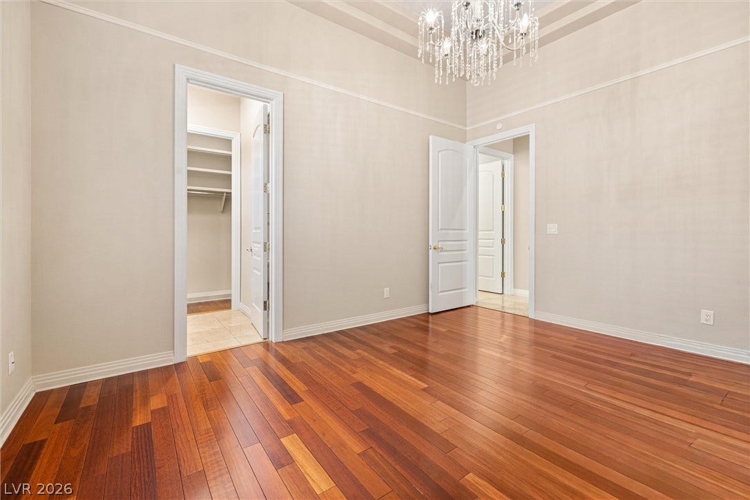 1517 Marbella Ridge Court, Las Vegas, NV 89117 Rich hardwood flooring complements the tray ceiling and elegant lighting in this versatile space.