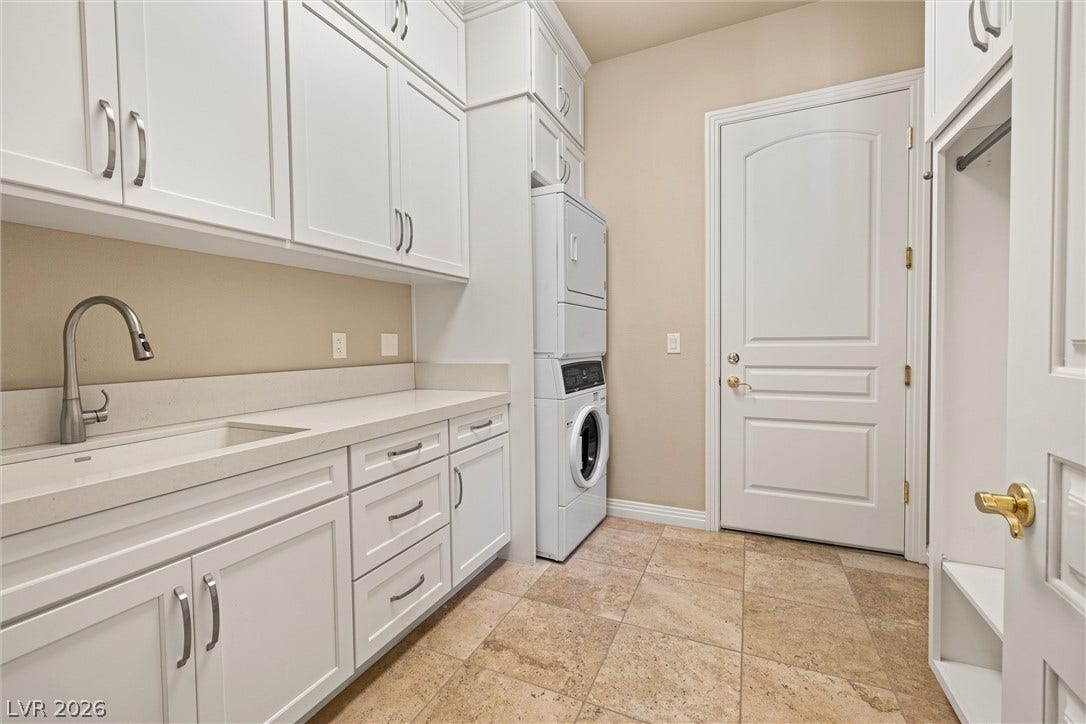 1517 Marbella Ridge Court, Las Vegas, NV 89117 A functional laundry area boasts extensive white cabinetry and tile flooring.