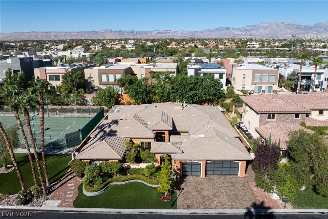 1517 Marbella Ridge Court, Las Vegas, NV 89117 An aerial perspective showcases a tile-roofed home set against a mountain backdrop.