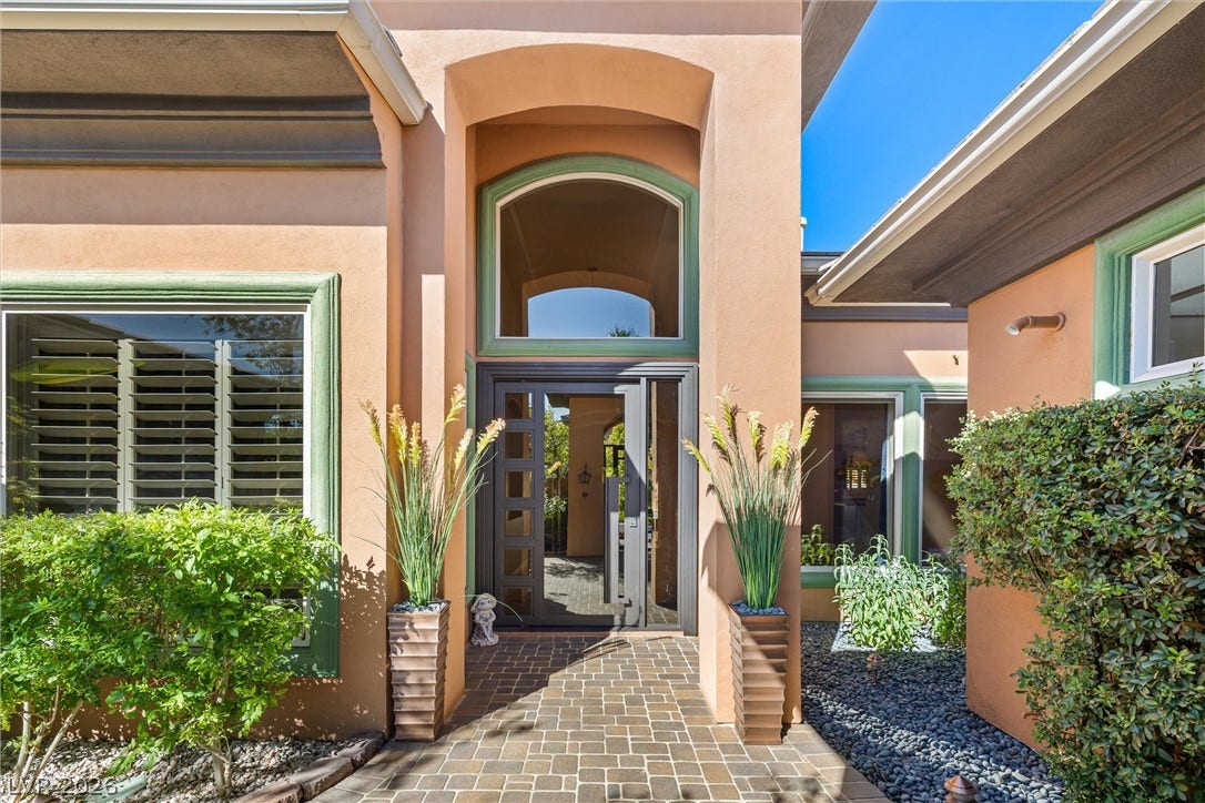 1517 Marbella Ridge Court, Las Vegas, NV 89117 An inviting stone-paved walkway leads directly to the recessed grand double-door entrance.