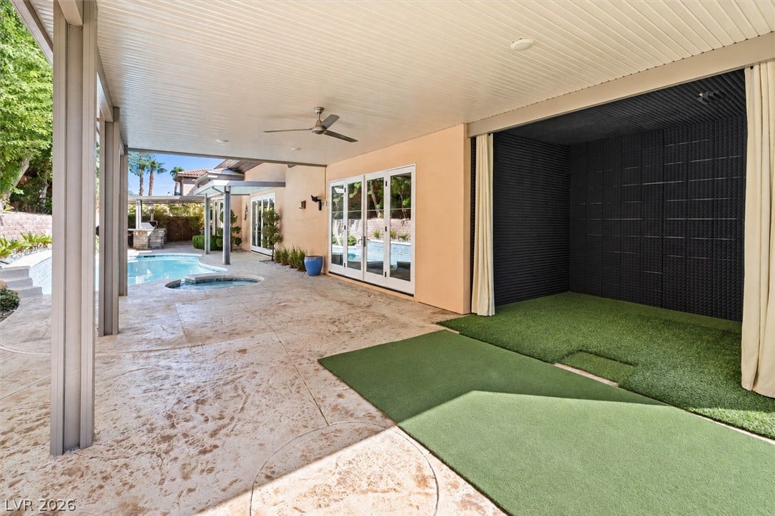 1517 Marbella Ridge Court, Las Vegas, NV 89117 Sheltered outdoor living transitions seamlessly to a poolside patio through classic glass French doors and golf bay