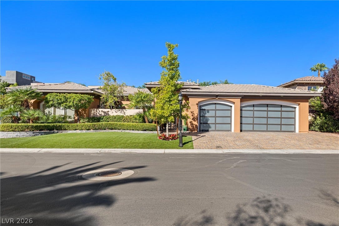 1517 Marbella Ridge Court, Las Vegas, NV 89117 A beautifully manicured lawn and brick-paved driveway frame this elegant single-story facade.