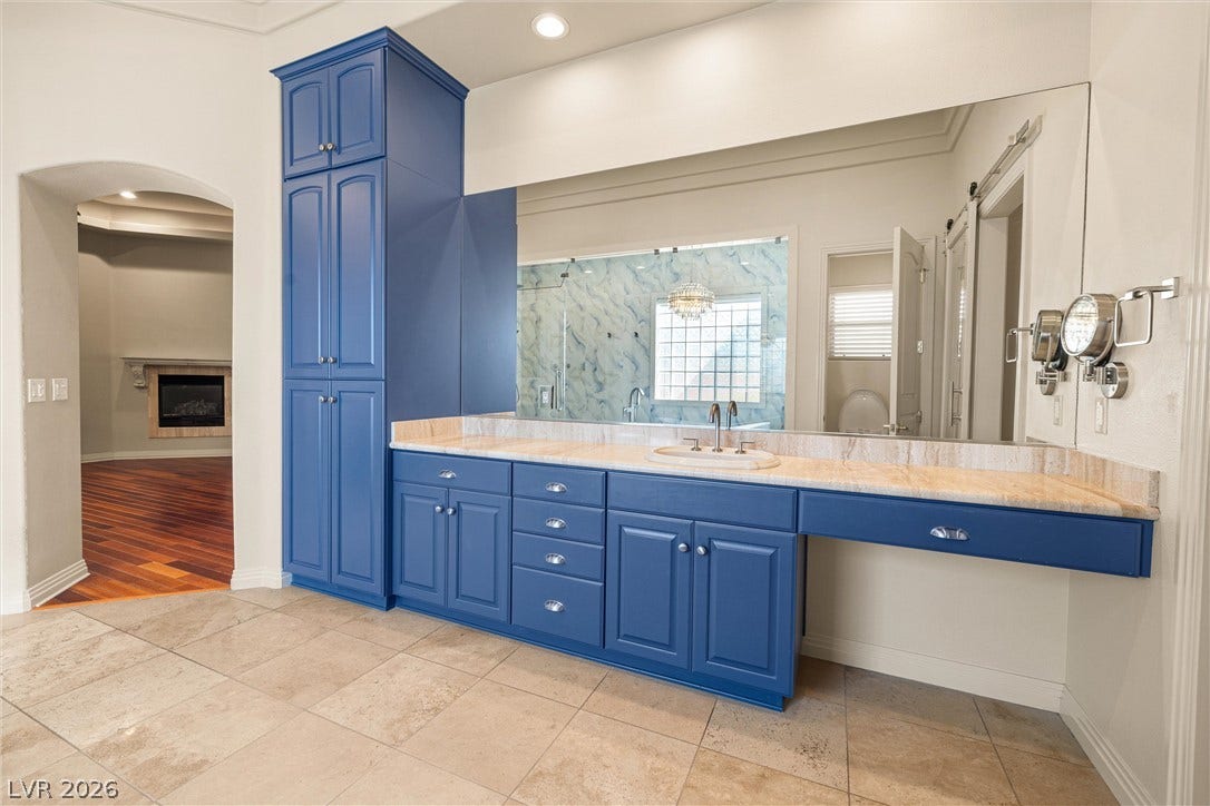 1517 Marbella Ridge Court, Las Vegas, NV 89117 Gleaming tile floors and custom cabinetry anchor this primary bath vanity area.