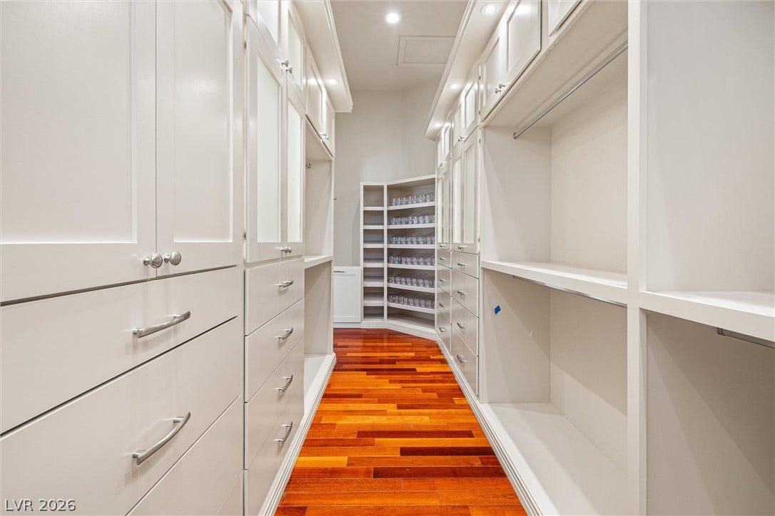 1517 Marbella Ridge Court, Las Vegas, NV 89117 Gleaming hardwood floors run through a spacious closet equipped with custom built-in cabinetry.