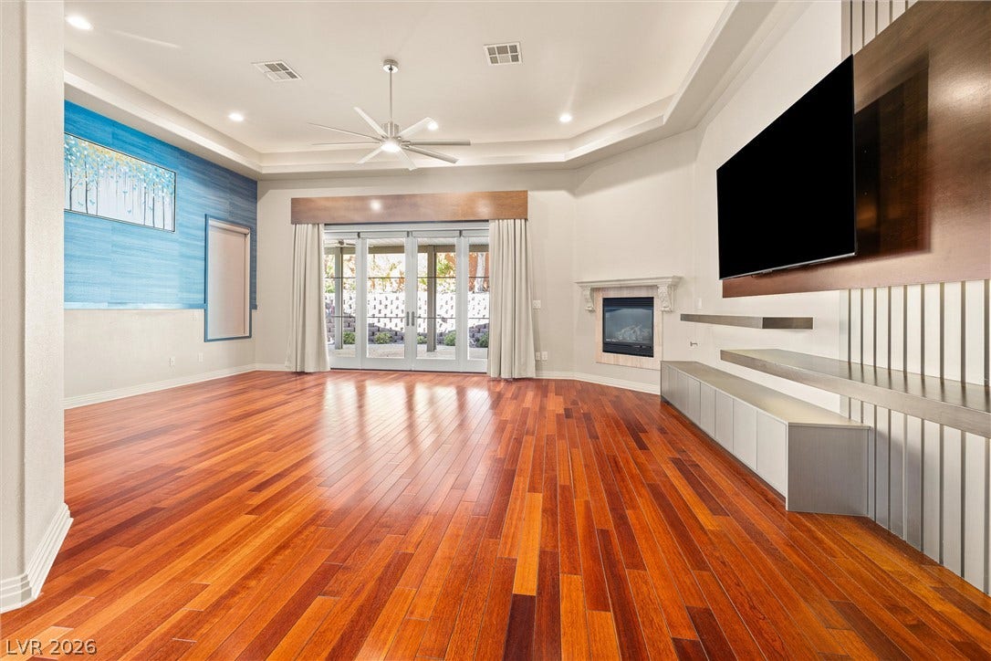 1517 Marbella Ridge Court, Las Vegas, NV 89117 Gleaming hardwood floors run throughout this living space containing a recessed fireplace.