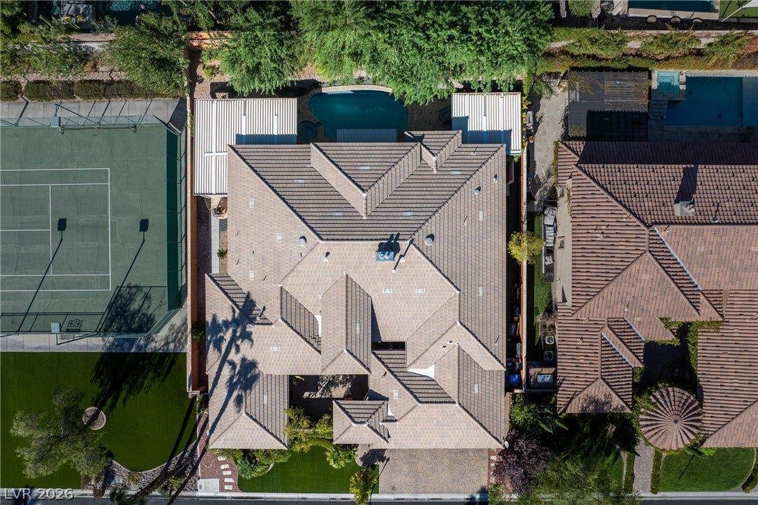 1517 Marbella Ridge Court, Las Vegas, NV 89117 A classic tile roof caps this spacious residence nestled alongside an expansive tennis court.