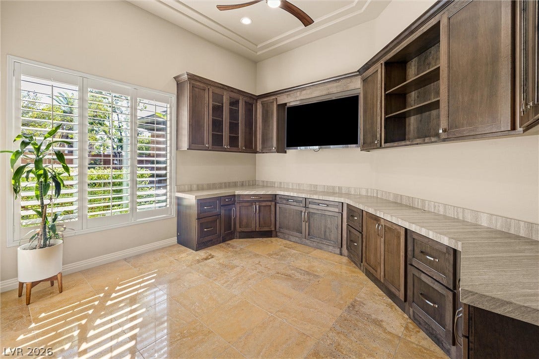 1517 Marbella Ridge Court, Las Vegas, NV 89117 Gleaming tile floors and custom cabinetry with stone counters define this versatile home workspace.