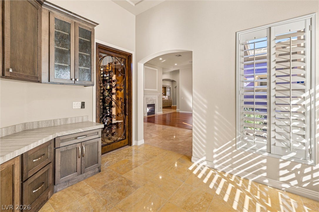 1517 Marbella Ridge Court, Las Vegas, NV 89117 Polished tile flooring, custom cabinetry, and plantation shutters define this versatile transition space.