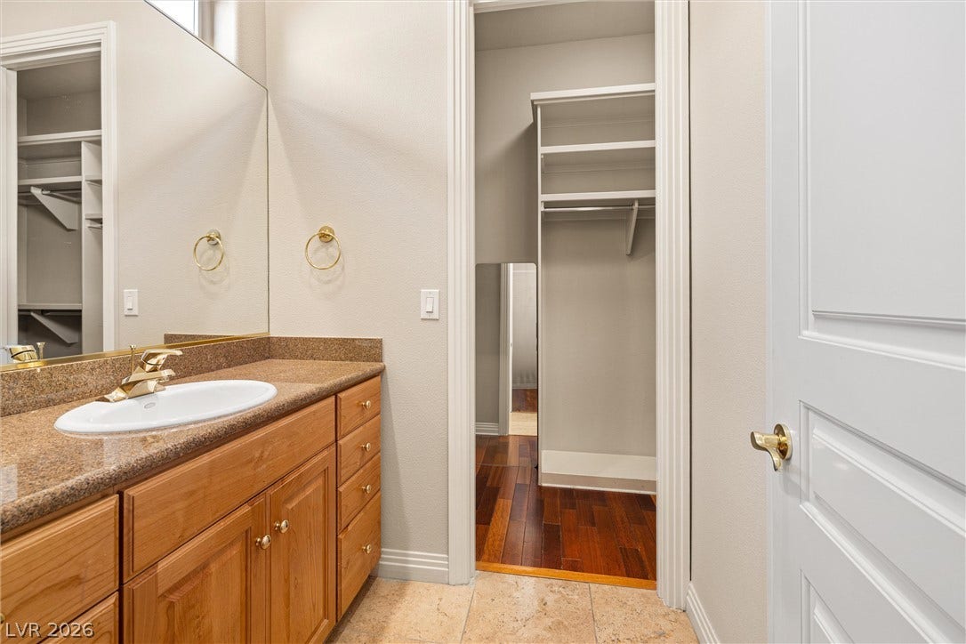 1517 Marbella Ridge Court, Las Vegas, NV 89117 A well-appointed vanity area opens directly into a spacious walk-in closet with built-in shelving.