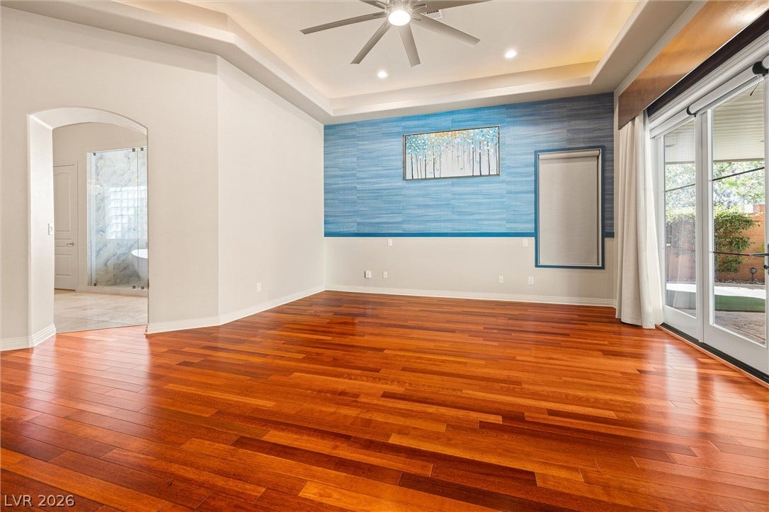 1517 Marbella Ridge Court, Las Vegas, NV 89117 Gleaming hardwood floors and a recessed tray ceiling define this spacious master bedroom retreat.