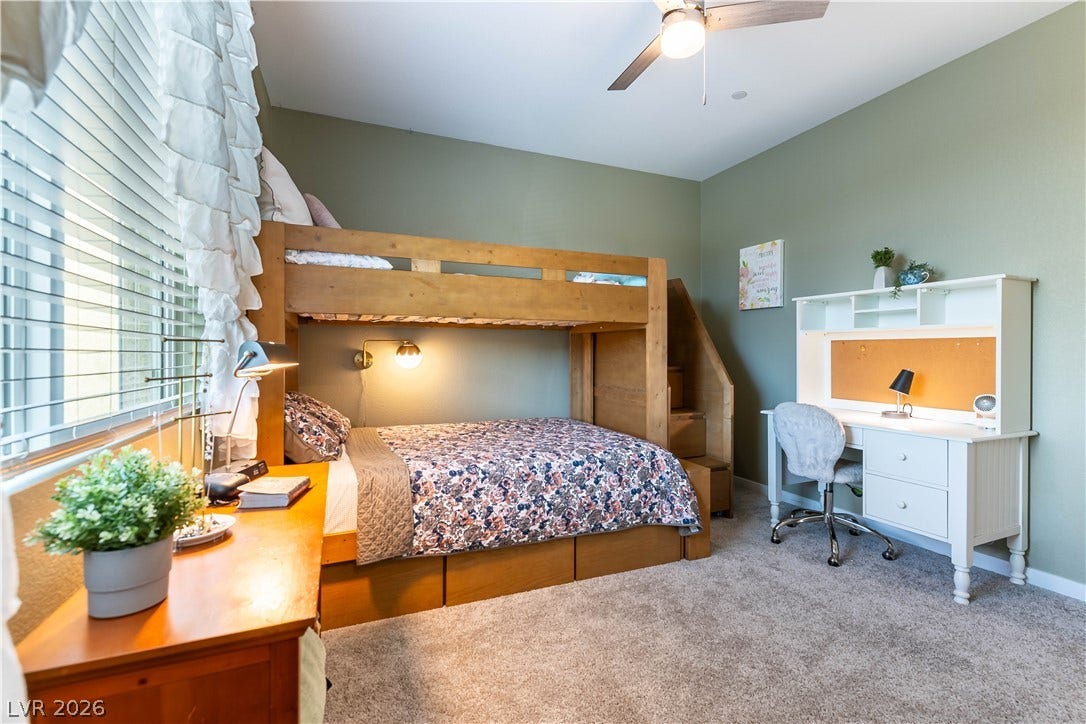 10583 Valletta Avenue, Las Vegas, NV 89166 Plush carpeting and generous natural light from a wide window define this comfortable bedroom.