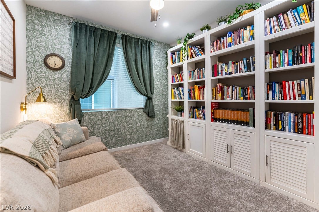 10583 Valletta Avenue, Las Vegas, NV 89166 An inviting reading room highlights custom floor-to-ceiling built-in bookcases and plush carpet underfoot.