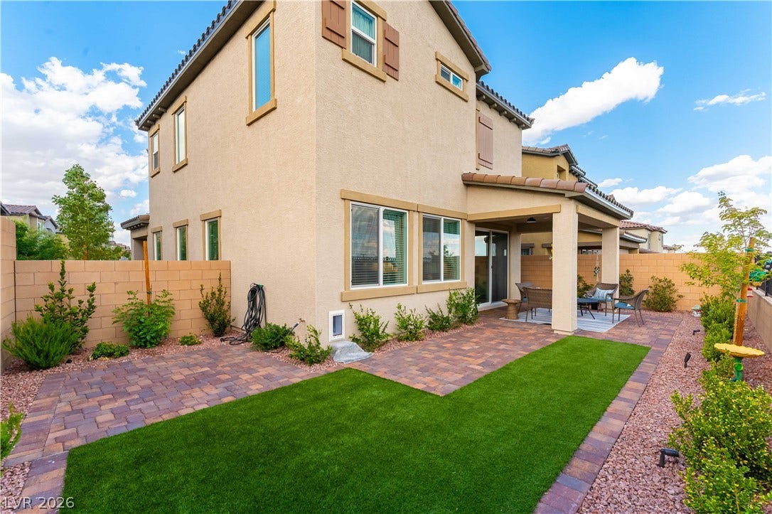 10583 Valletta Avenue, Las Vegas, NV 89166 An inviting covered patio opens onto a meticulously landscaped backyard featuring low-maintenance turf.