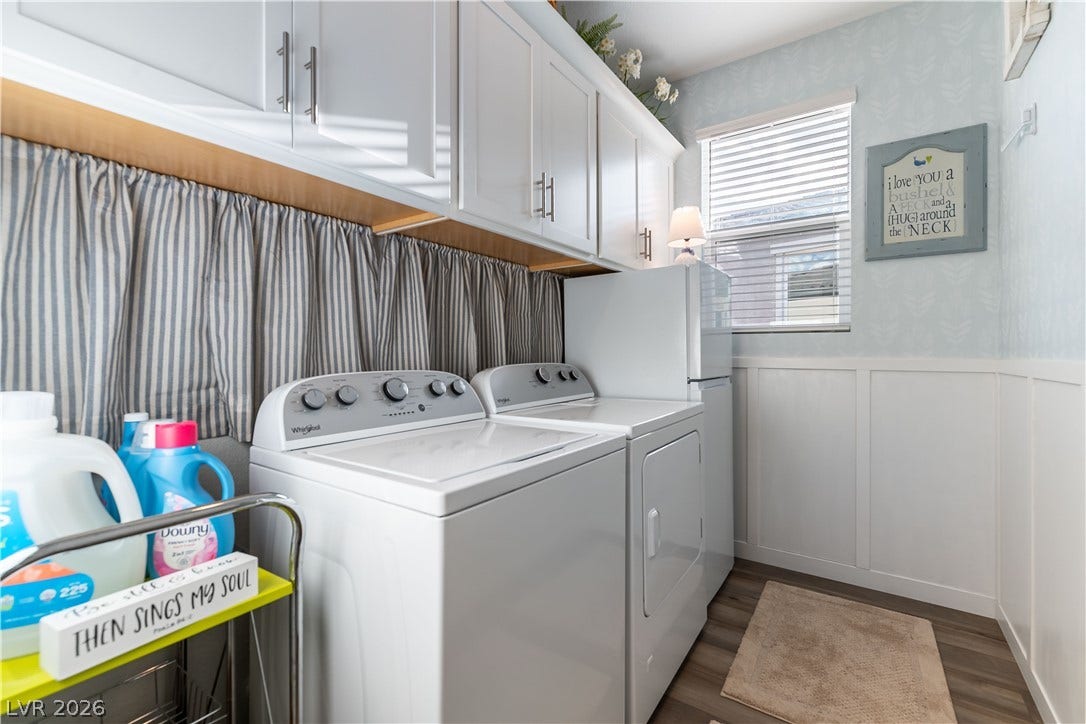10583 Valletta Avenue, Las Vegas, NV 89166 Crisp white cabinetry and clean wainscoting define this functional home laundry space.