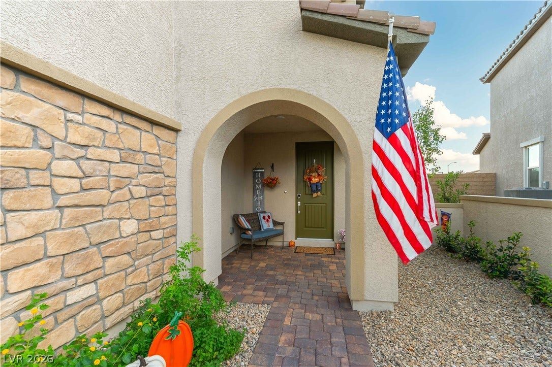 10583 Valletta Avenue, Las Vegas, NV 89166 An arched entry framed by stone veneer accents leads to the covered front porch.