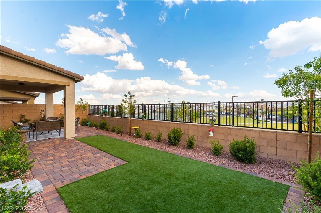 10583 Valletta Avenue, Las Vegas, NV 89166 An inviting covered patio opens directly onto a neat paved terrace and manicured lawn.