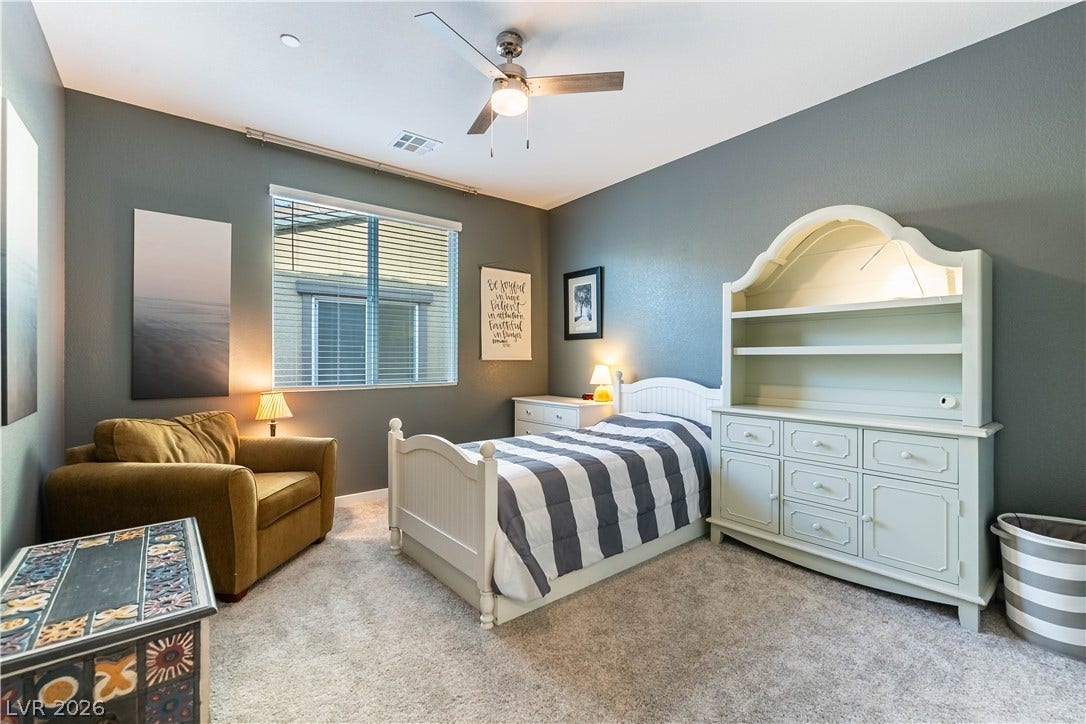 10583 Valletta Avenue, Las Vegas, NV 89166 A window fills the space with natural light highlighting the plush carpeted floor.