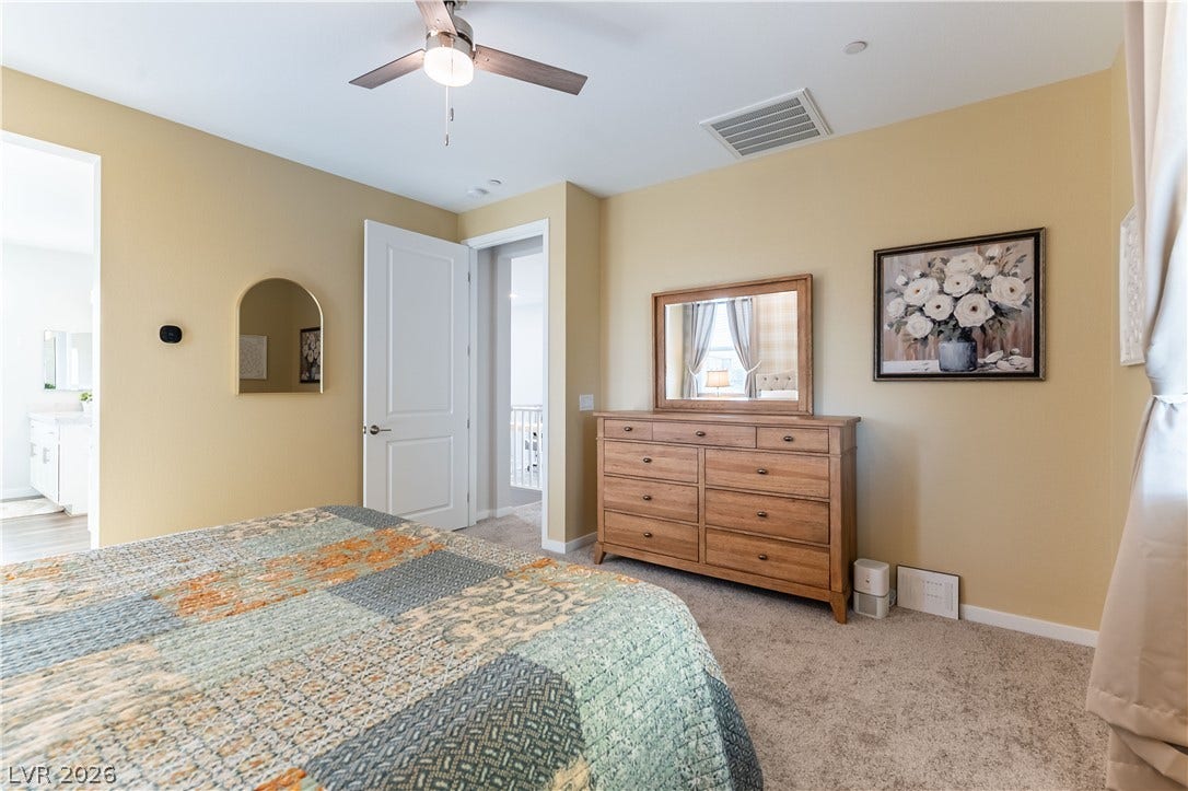 10583 Valletta Avenue, Las Vegas, NV 89166 Plush carpeting underfoot warms this secondary sleeping space featuring an adjacent bathroom vanity view.