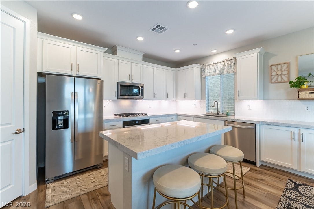 10583 Valletta Avenue, Las Vegas, NV 89166 Polished stone counters and clean white cabinetry anchor this modern culinary space.