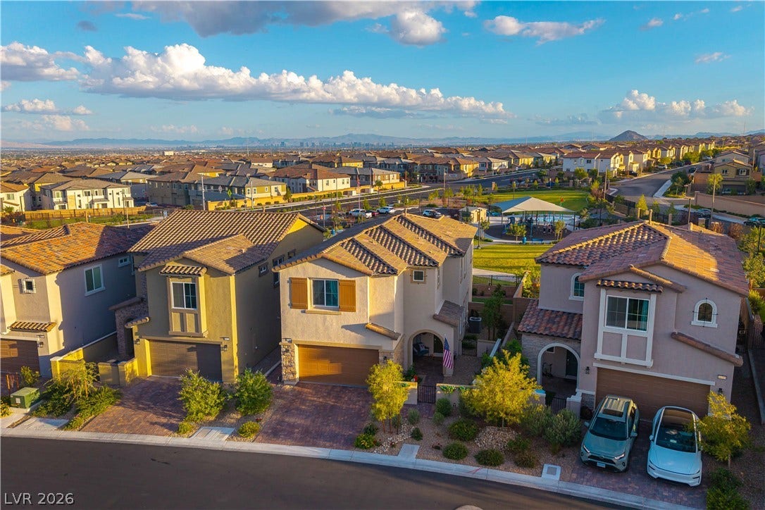 10583 Valletta Avenue, Las Vegas, NV 89166 An aerial perspective captures modern multi-level homes nestled alongside a neighborhood park.
