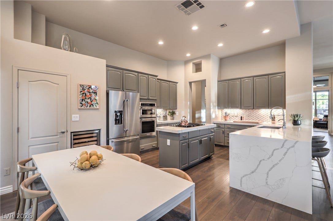 Elegant quartz waterfall countertops and sleek cabinetry elevate this chef-inspired workspace.
