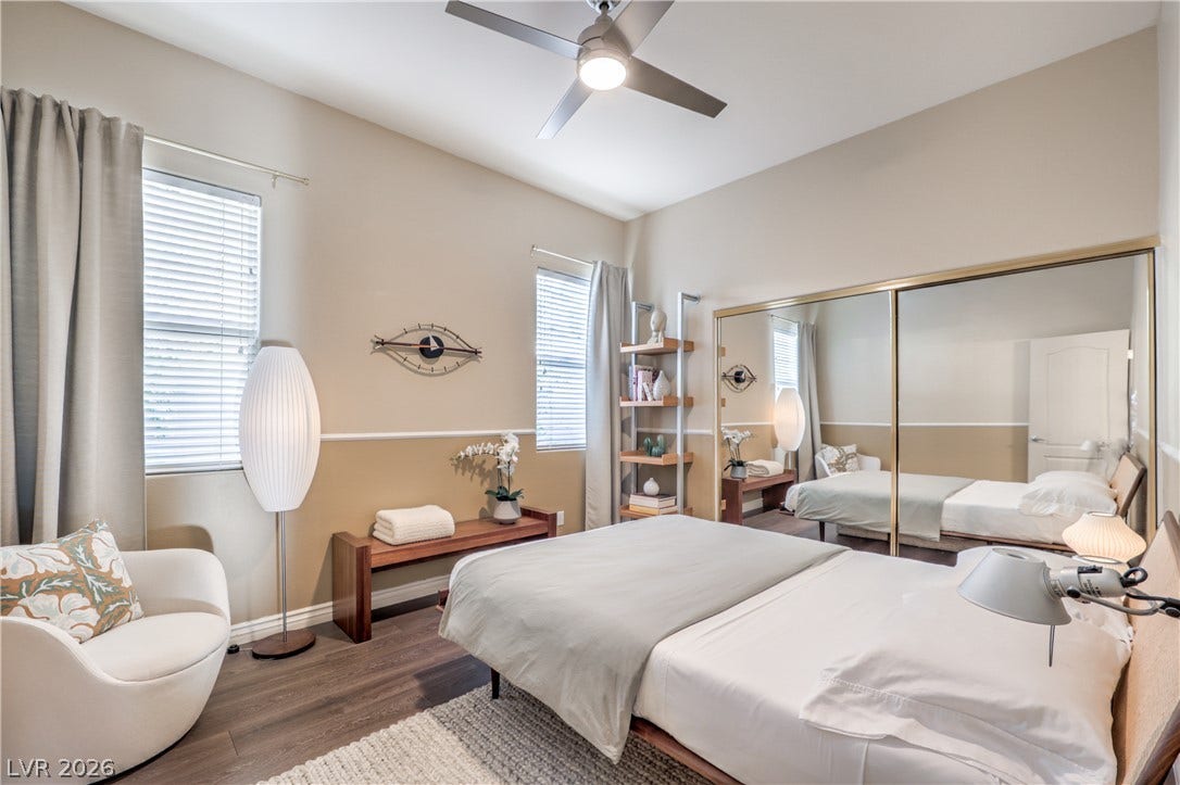 Plentiful natural light filters through dual windows, highlighting the warm wood flooring.