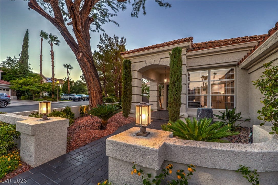 Spanish tile roofing and custom stucco details define this classic exterior design.